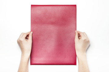 woman hand hold a red leather envelope isolated white.