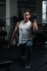 Fototapeta na wymiar Gym workout. Young, muscular man training in gym