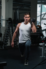 Fototapeta na wymiar Fitness man doing exercises with dumbbell at gym