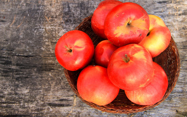 Red apples on wooden background