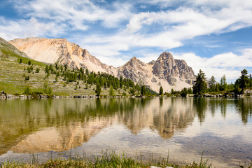 Mountains reflecting in transparent lake water