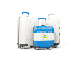 Luggage with flag of nicaragua. Three bags isolated on white