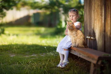 girl sitting on a bench with a cat