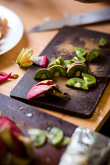 Organic fresh kiwi fruit on a wooden cutting board and utensils. rustic style. toned picture. close up and selective focus,Fresh kiwis fruit and spoon on wooden board.Sliced kiwi