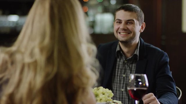 curling blondie telling to partner in restaurant