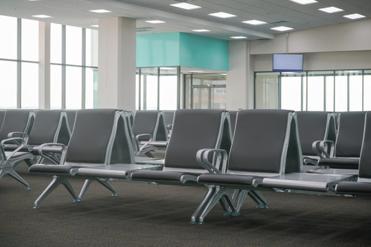 waiting area at airport terminal with empty chairs