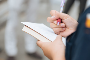 Apprentice taking notes from the trainer. Handwriting. Creative writing. Inscription or recording of signs and symbols.