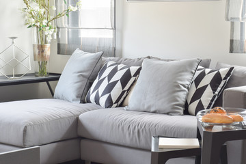 Black and white parallelogram pattern pillows on gray comfy sofa