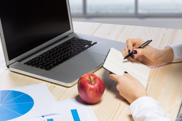 Business woman in an office holding red apple - Clipping Path