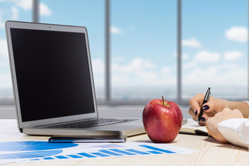 Business woman in an office holding red apple - Clipping Path