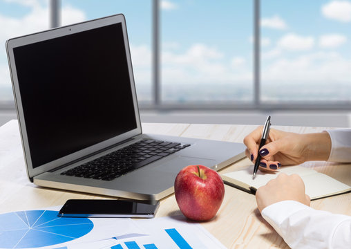 Business woman in an office holding red apple - Clipping Path