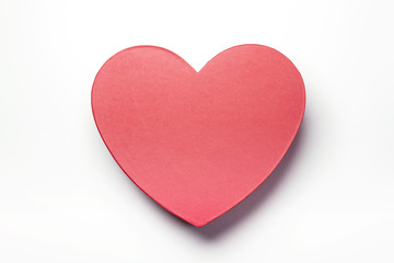 Woman hand hold a red heart gift box isolated white.