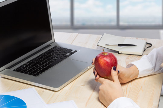 Business woman in an office holding red apple - Clipping Path