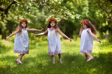 Naklejka premium three beautiful sisters happily having fun in the garden