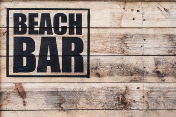 close up view of beach bar logo stamped on wooden surface