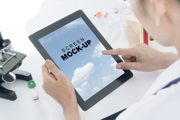 Woman doctor using her tablet in labs
