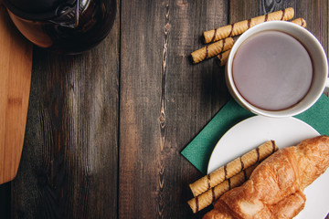 drink in a cup, sweet rolls and croissants