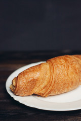 croissants in a plate on a dark background