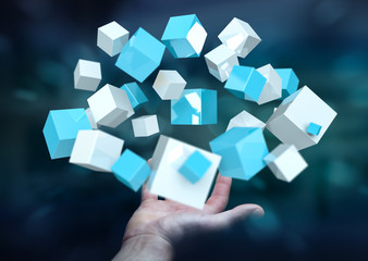 Businessman holding flying blue shiny cube 3D rendering