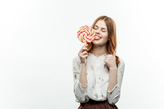 happy woman with a round lollipop, white teeth