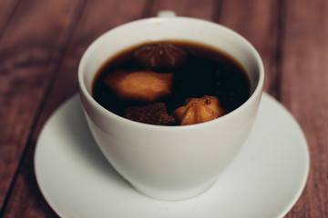 a light cup, a biscuit in a drink