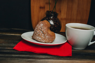 cupcake in a saucer and a cup with a drink