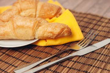 yellow napkin and two croissants