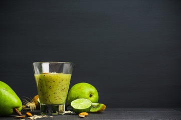 Kiwi smoothie with pears, oats, limes and almond on the wooden background