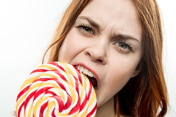 woman biting round lollipop