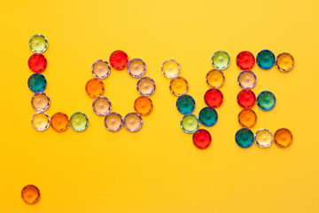 multicolored stones, inscription on a yellow background