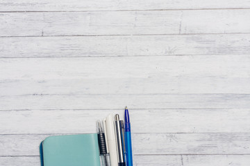 business card and pens on a wooden background