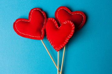 fabric hearts on a blue background, wooden stick