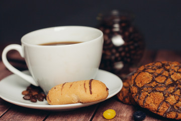 cup with a drink and a liver saucer, coffee beans in a jar