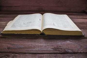 Vintage open book on wooden desk