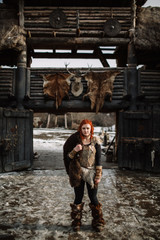 Obraz na płótnie Canvas The girl dressed in a Viking outfit.