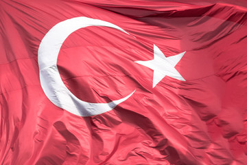 Picture of the official turkish flag hoisted in a windy environment