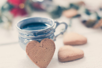 cup of coffee with cookies on a white background with ribbons