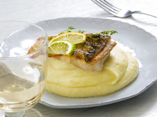 Fried perch with mashed potatoes, lemon and lime slice