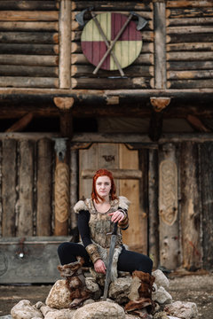 portrait of a girl in a Viking outfit, red hair.