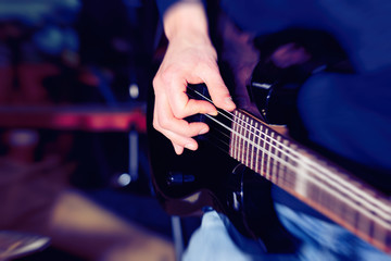 Hand  playing  guitar, close up
