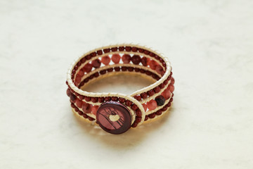 Handmade bracelet close up at marble stone pattern cardboard; no people, 