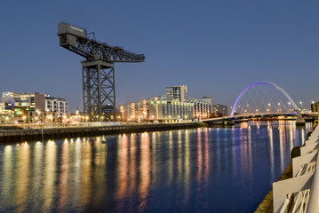View over River Clyde in central Glasgow including office buildings , the Finnieston Crane, and the Clyde Arc Bridge. 