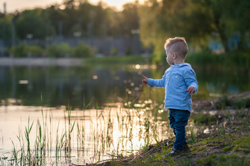 Fototapeta na wymiar Little boy in fashionable clothing in the park.