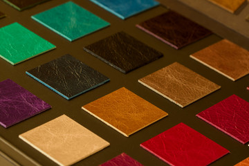 Colorful leather samples on dark background, choice of texture and color