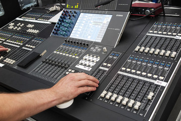 Hand operating sound system at concert. 
