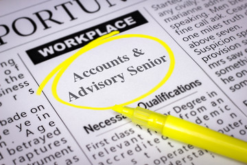 Accounts & Advisory Senior - Newspaper sheet with ads and job search, circled with yellow marker, Blurred image and selective focus