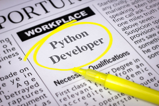Python Developer - Newspaper sheet with ads and job search, circled with yellow marker, Blurred image and selective focus