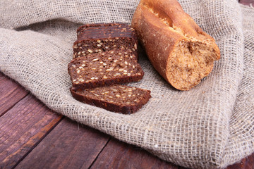 Sliced black bread on the old wooden plank