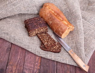 Sliced black bread on the old wooden plank