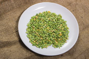 fruits green peas on a white plate